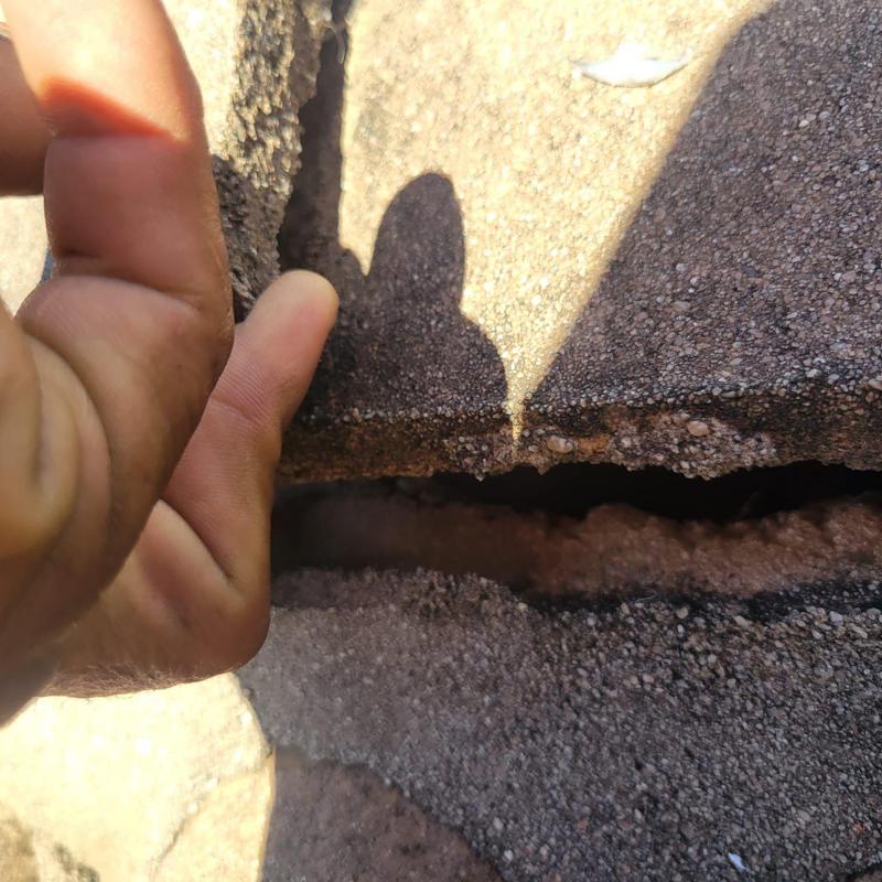 Concrete tile roof showing crack and lift gap