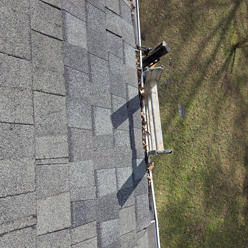 Roof shingles and gutter with ladder bracket installed