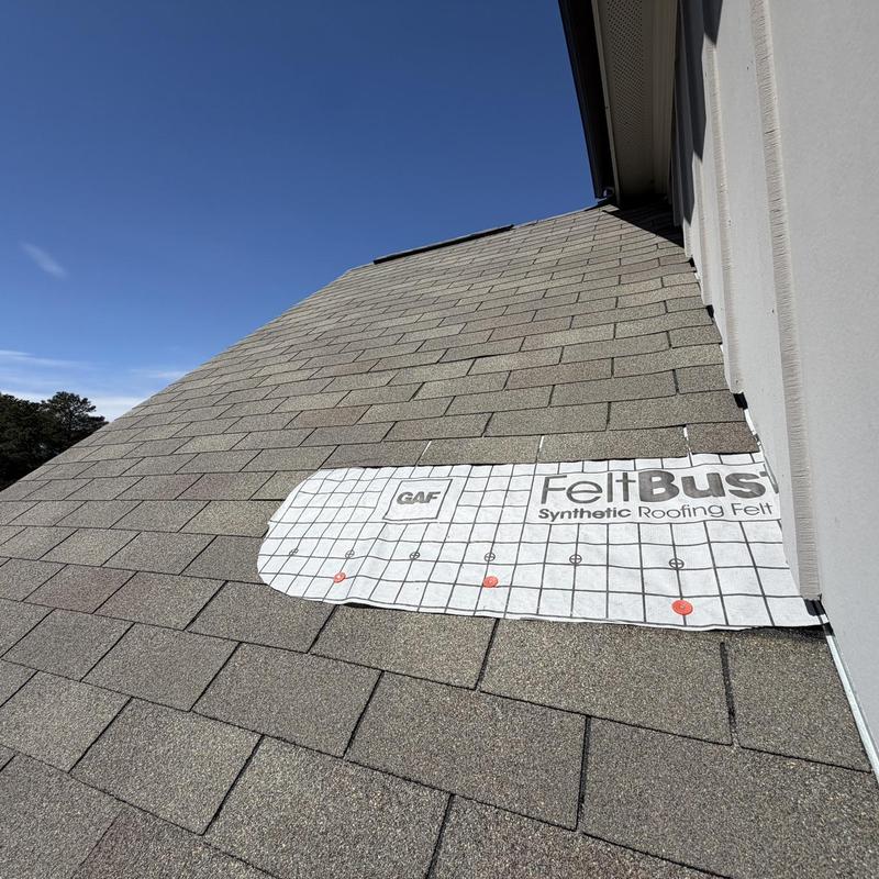 Damaged roof shingles with synthetic roofing felt installation