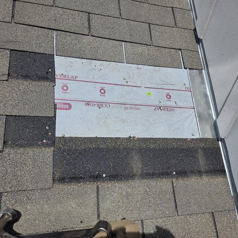 Roof shingles with underlayment exposed near flashing