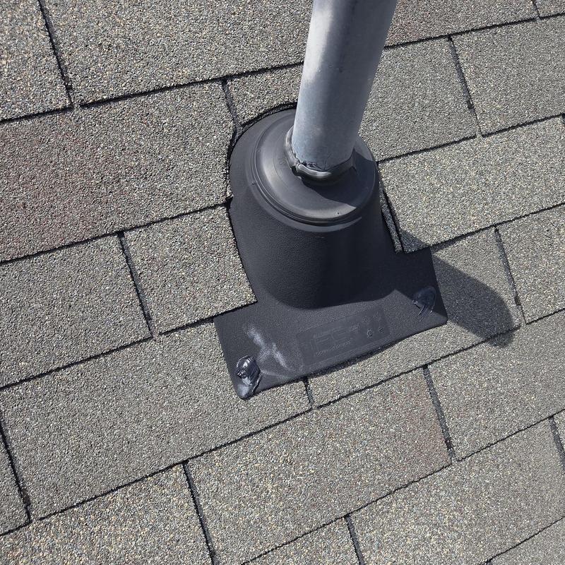 Roof pipe flashing with caulked seal on shingles