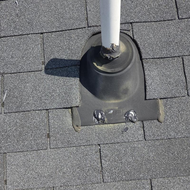 Roof pipe flashing with caulk and shingles replaced