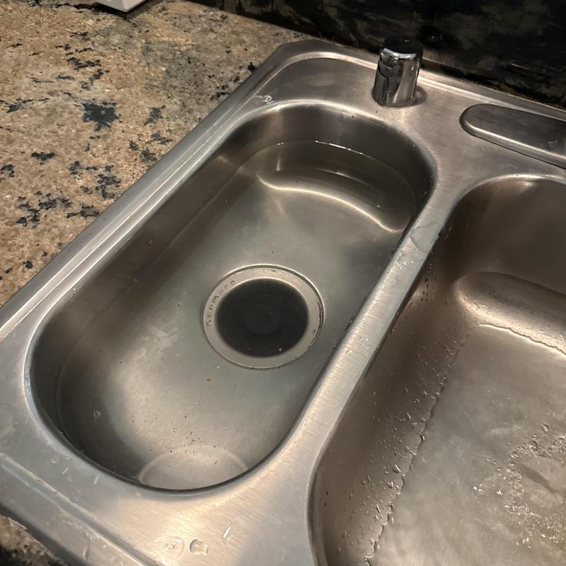 Kitchen sink with draining water and clean basin