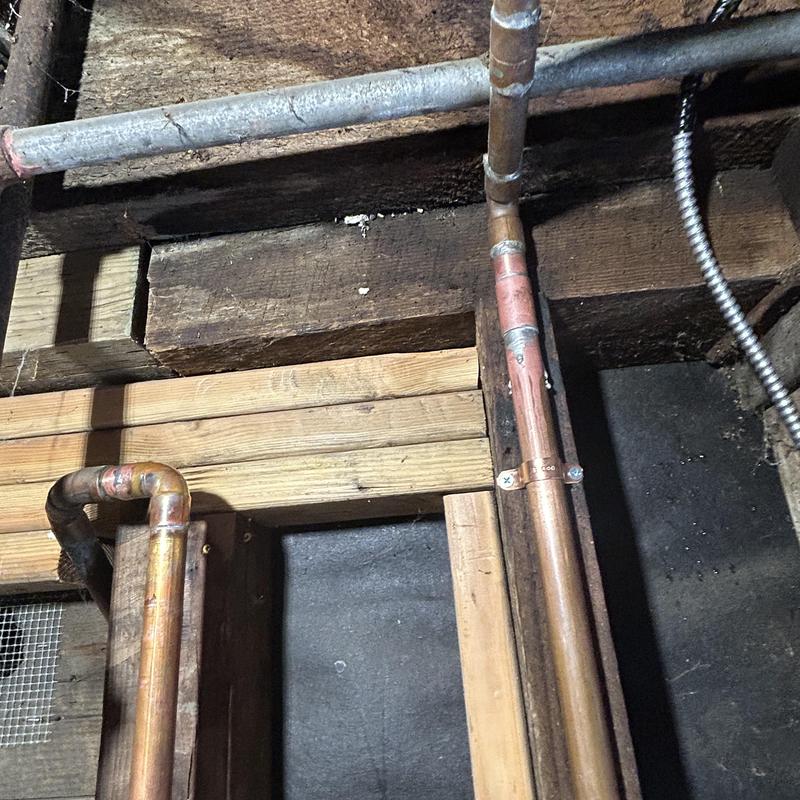 Copper water line with ball valve and strapping in garage