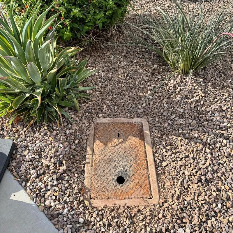 Irrigation valve box installed in gravel landscape