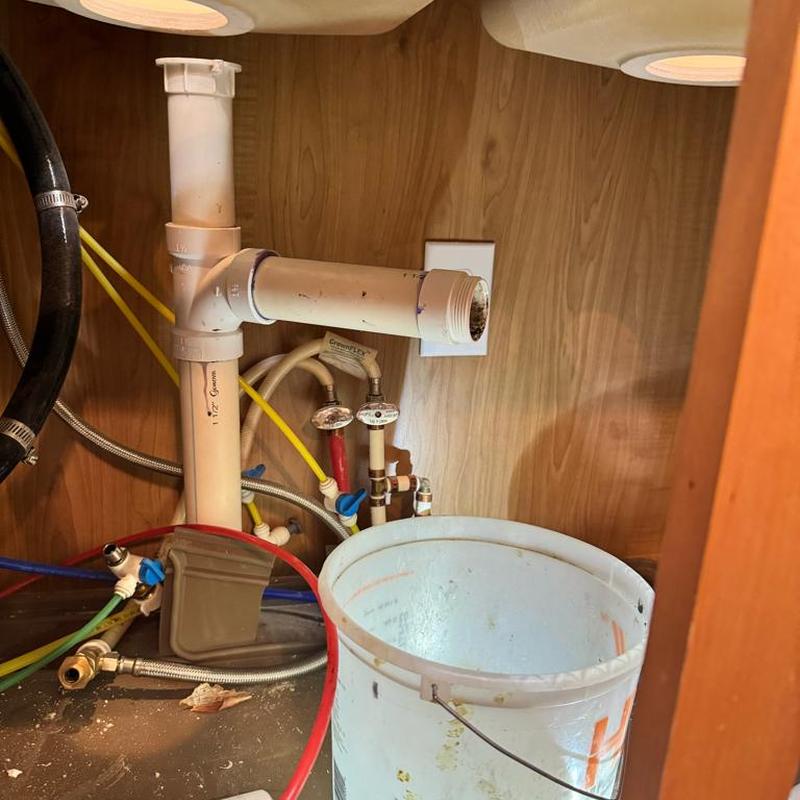 Garbage disposal drain pipe and plumbing connections under sink