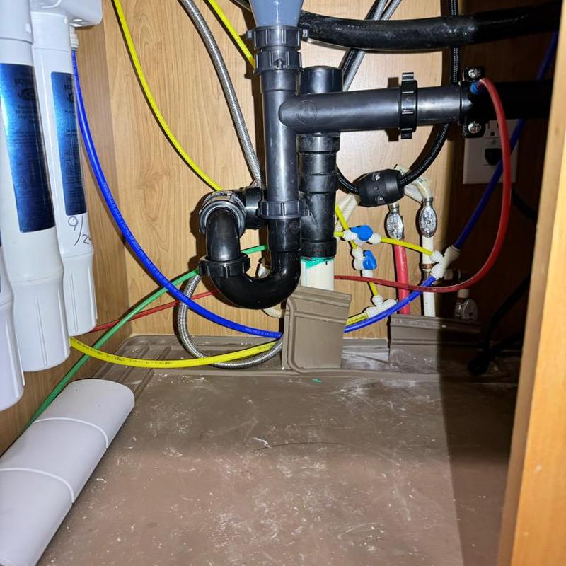 Reverse osmosis system and kitchen sink plumbing under cabinet