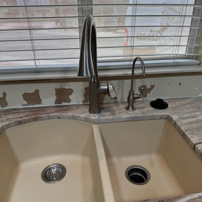 Kitchen faucet and reverse osmosis faucet installed over sink