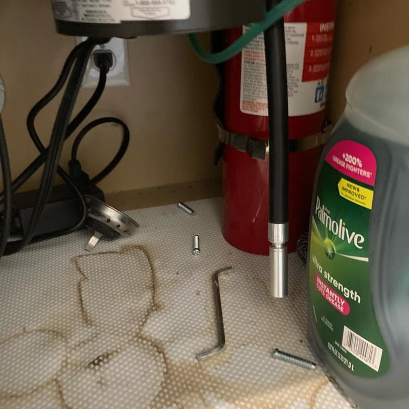 Disposal flange screws and seal under kitchen sink