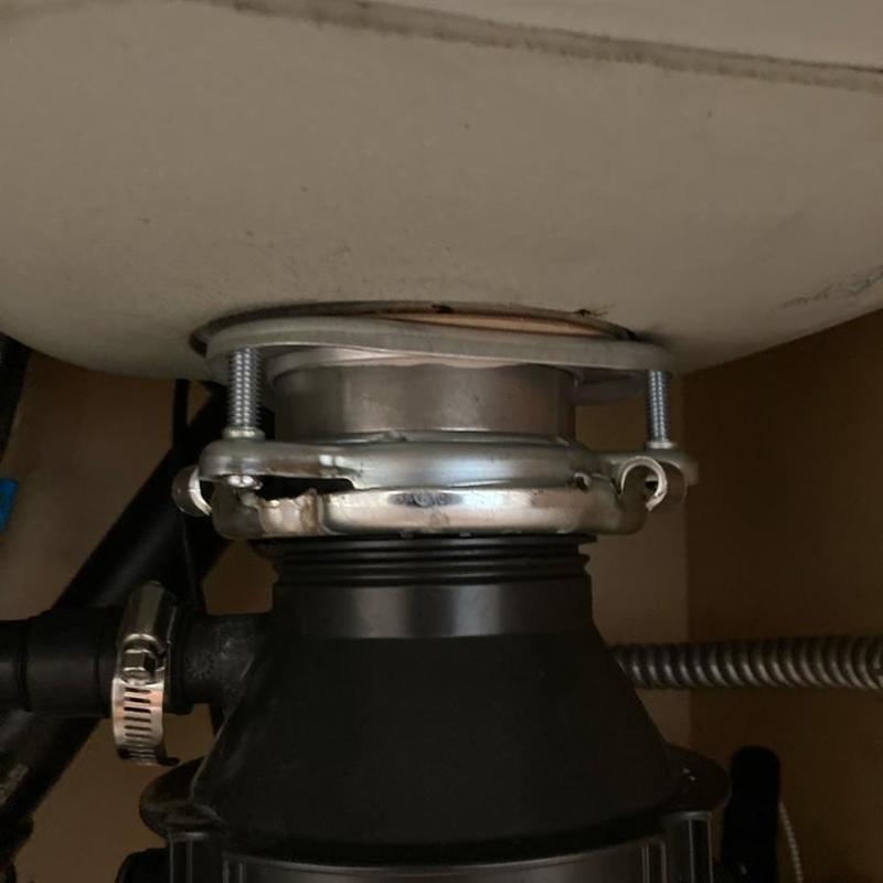 Disposal flange and sink seal under kitchen sink