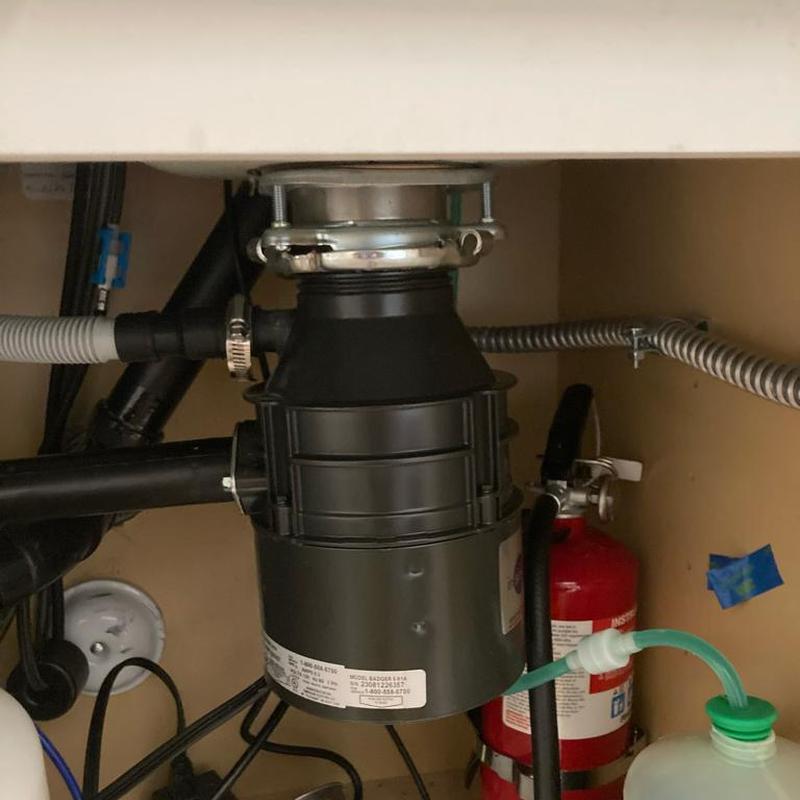 Garbage disposal with new flange under kitchen sink