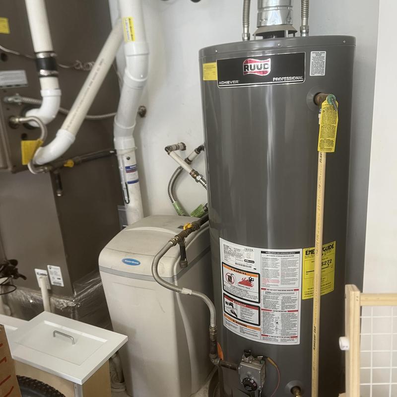 Tank water heater and water softener system in utility room