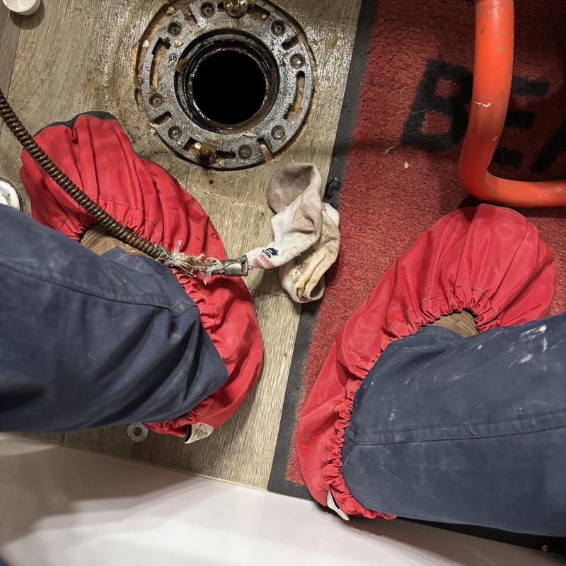 Mainline drain with toilet flange and clog removal tools