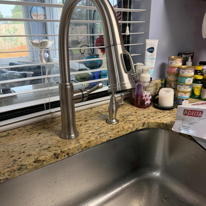 Kitchen faucet with soap dispenser on granite counter