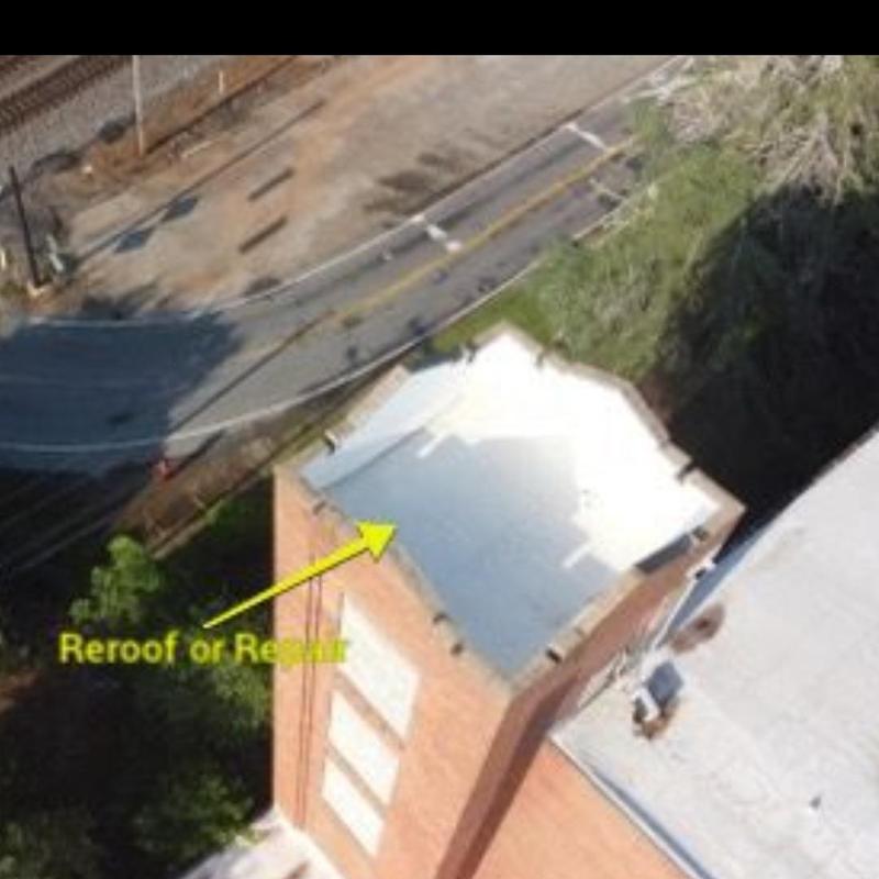 Commercial building flat roof with repair markings Commercial building flat roof with repair markings