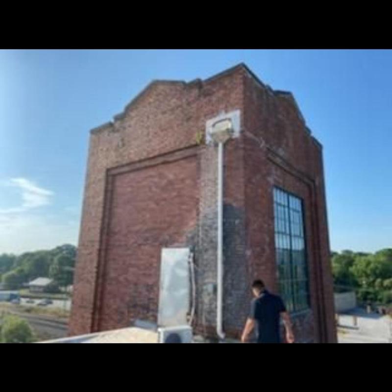 Brick chimney on commercial building roof in Spartanburg Brick chimney on commercial building roof in Spartanburg
