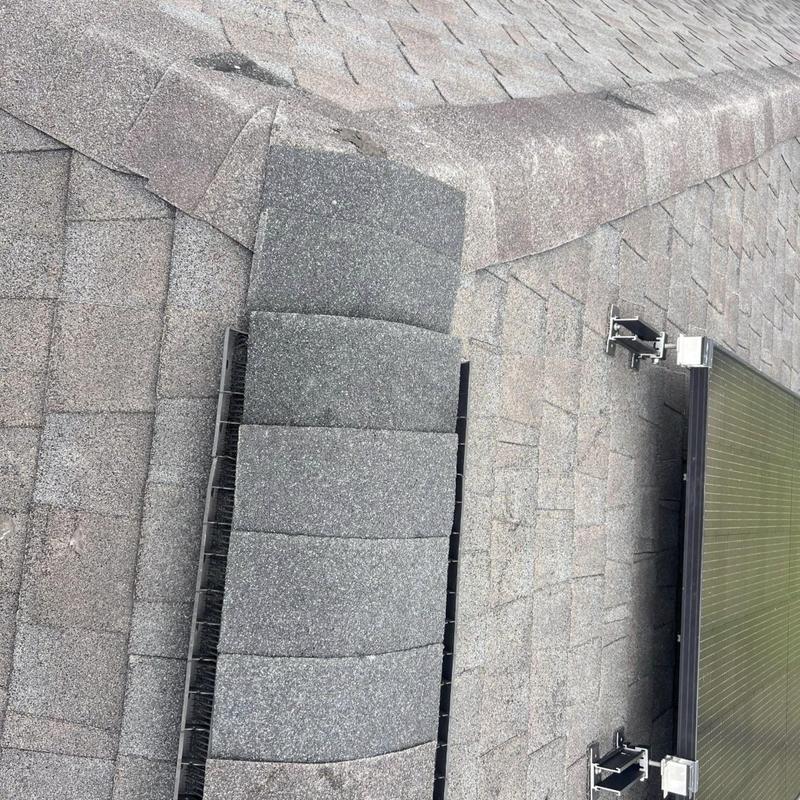Ridge cap shingles with new flashing and solar mounts