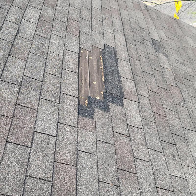 Asphalt shingle roof with missing shingles after hail damage