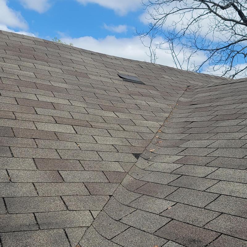 Asphalt shingle roof with visible hail damage