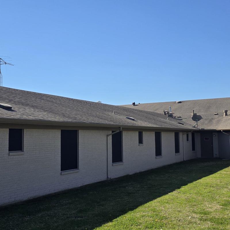 Asphalt shingle roof with hail damage on residential building