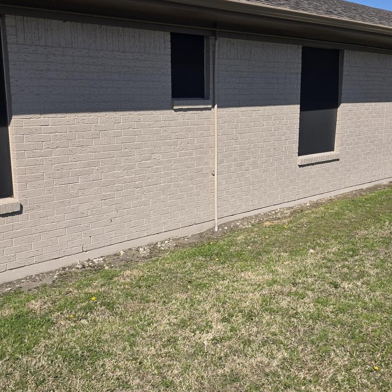 Brick exterior wall and foundation with minor damage