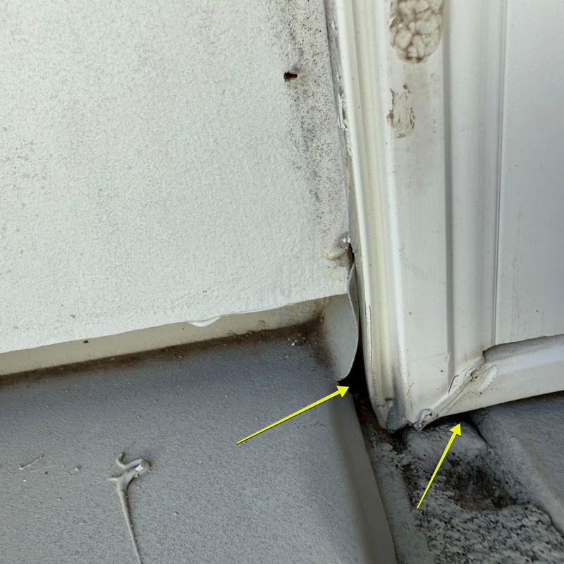 Garage door bottom corner with damaged trim and seals