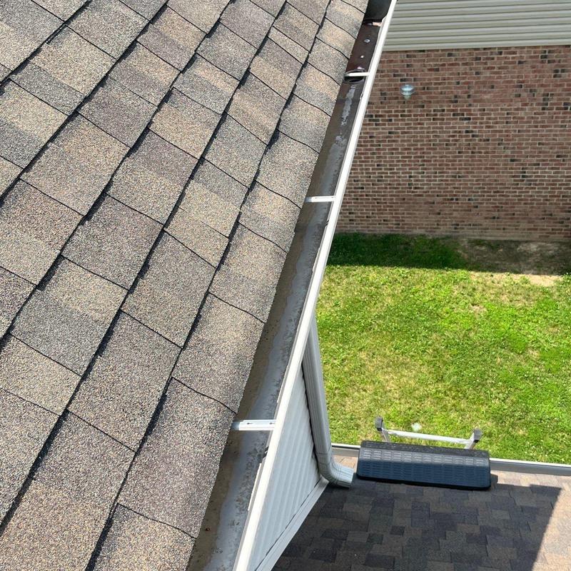 Asphalt shingles with hail damage and gutter system view