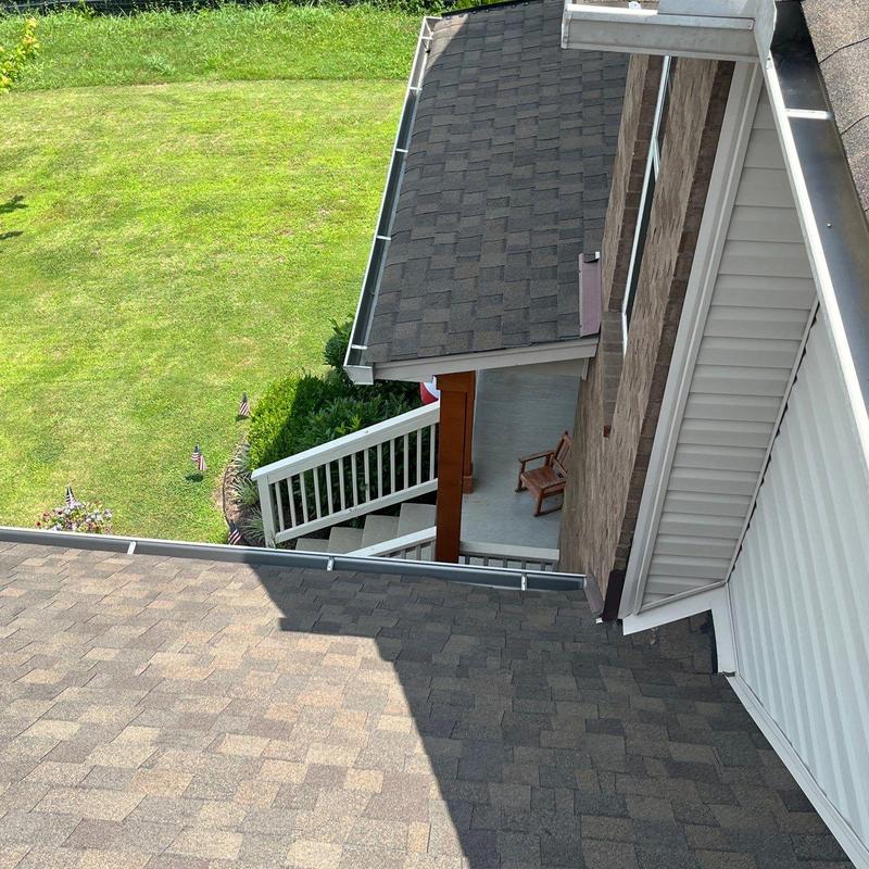 Asphalt shingle roof with gutter and porch view