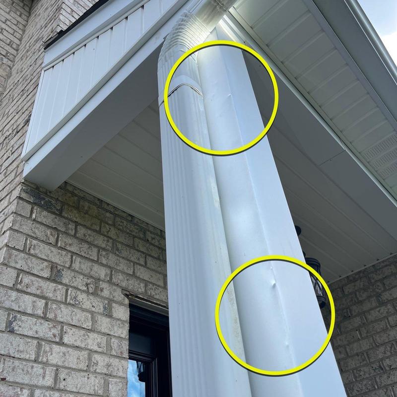 Vinyl downspout with dent and impact damage