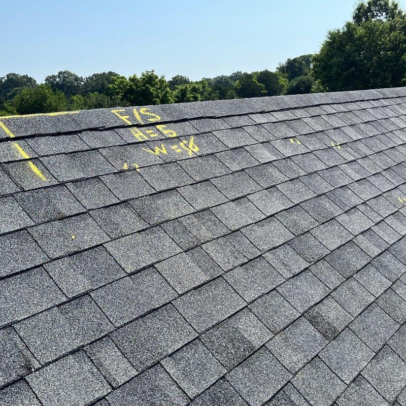 Asphalt shingle roof with hail damage markings