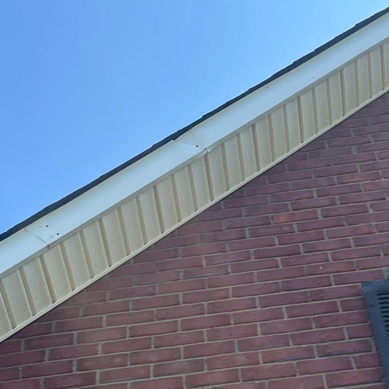 Roof edge trim and soffit on brick house exterior