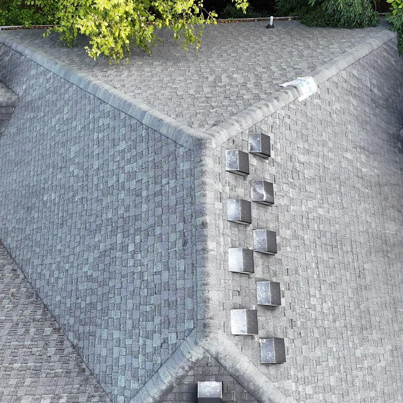 Roof shingles with ventilation vents on residential roof