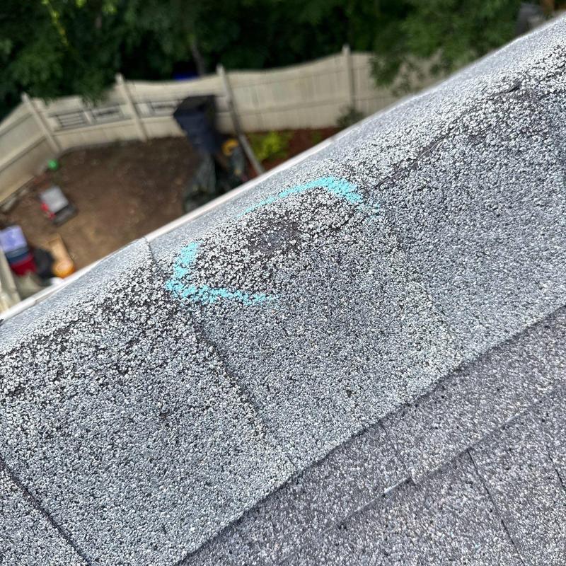 Asphalt shingle roof hail damage marked for repair