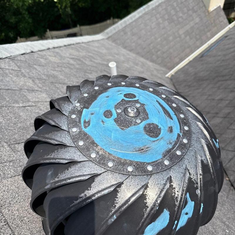 Turbine roof vent with worn paint on shingles