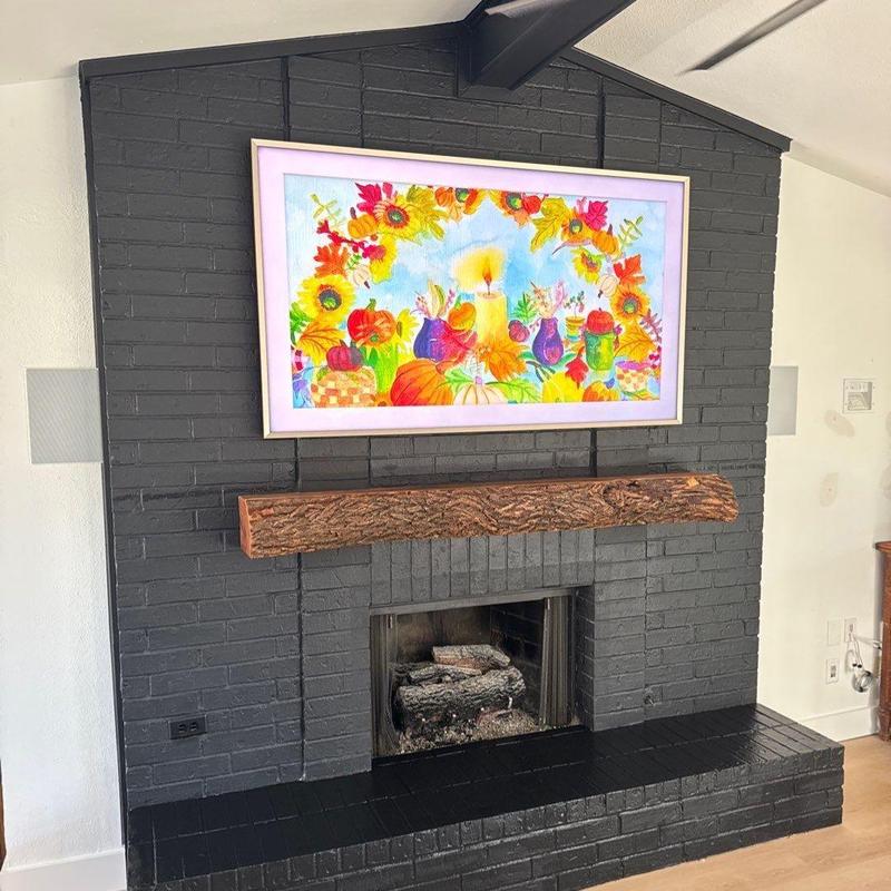 Rustic fireplace mantel on painted black brick fireplace