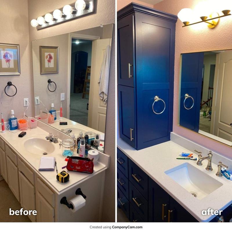 Bathroom vanity with quartz countertop and navy cabinets