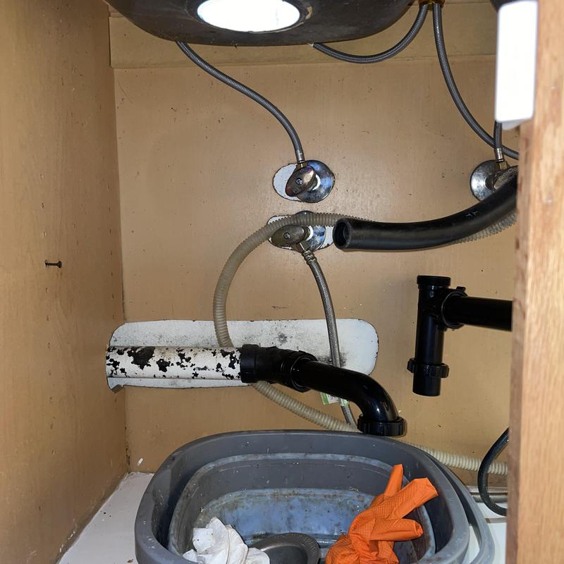 Garbage disposal drain lines and plumbing connections under sink