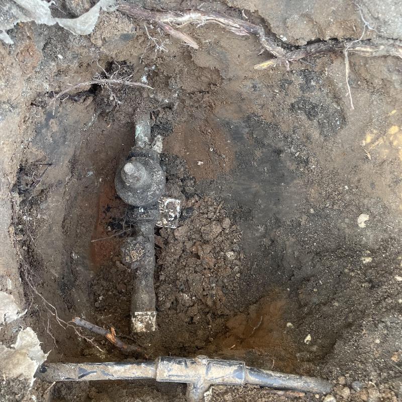 Pressure reducing valve exposed in dirt excavation site