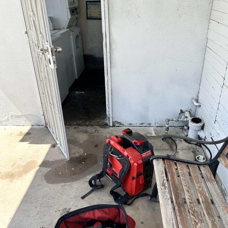 Building drain clog with sewer machine cable cleaning