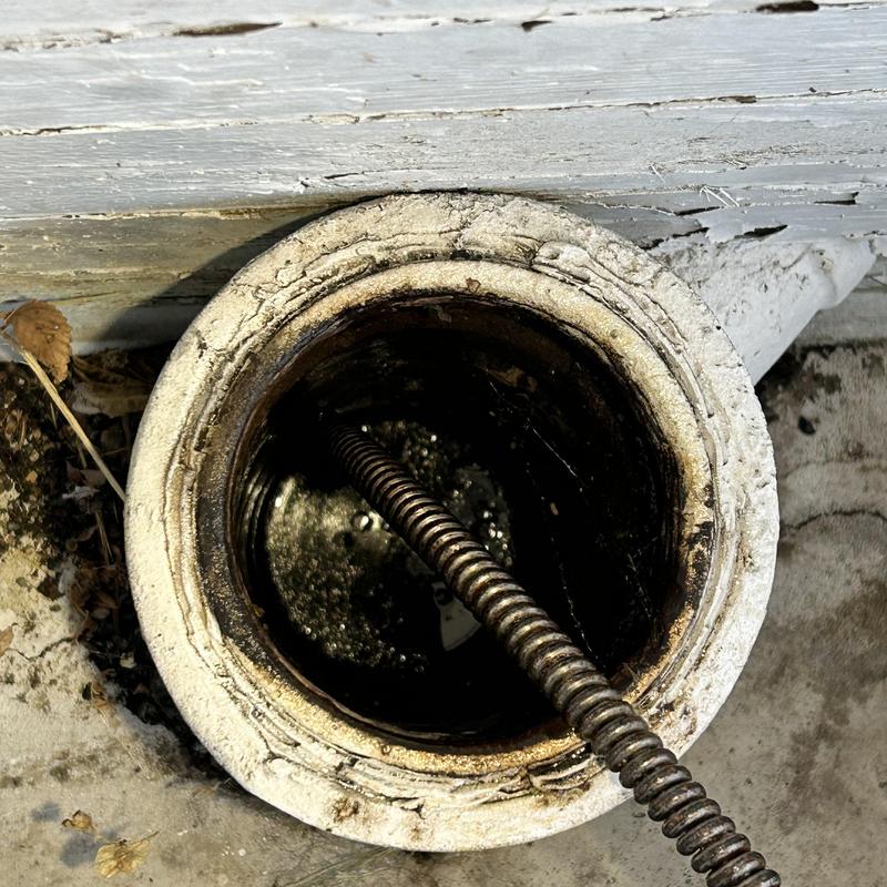 Building drain with sewer cable clearing blockage