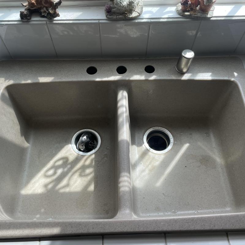 Kitchen sink with missing faucet and four mounting holes