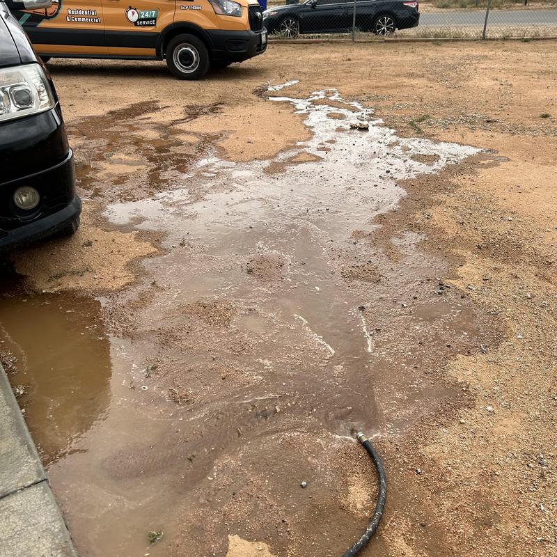 Water hose leak causing muddy ground and water pooling