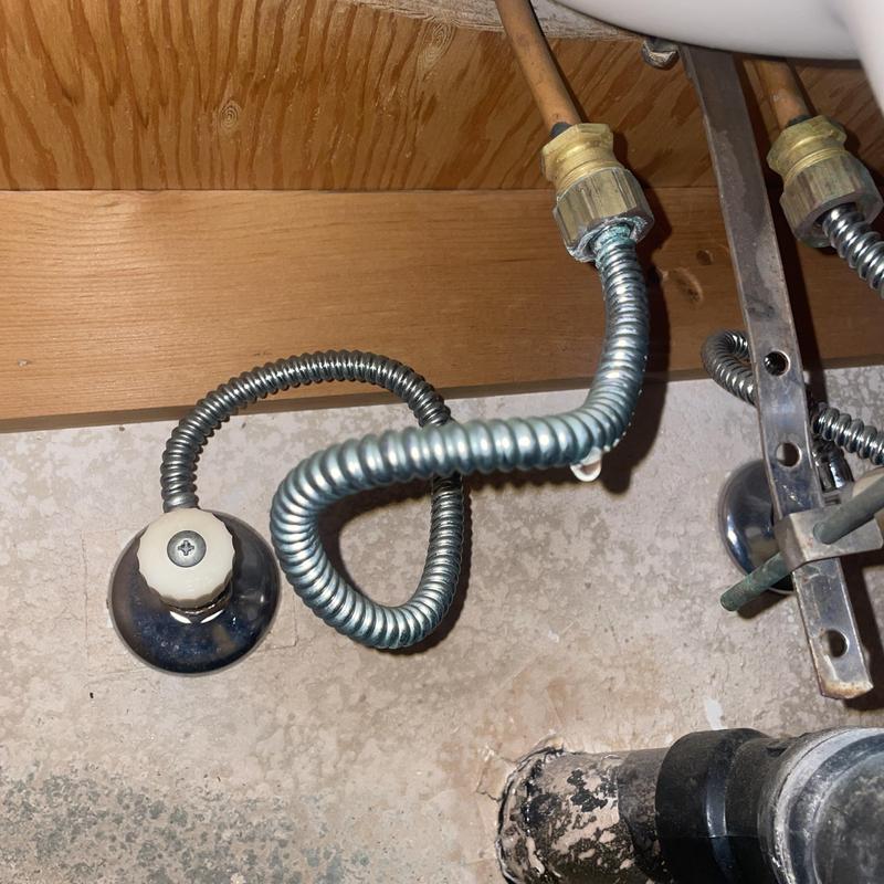 Angle stop valve with stainless steel supply line under sink