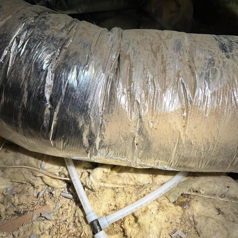Pex water pipe reroute under insulated duct in attic