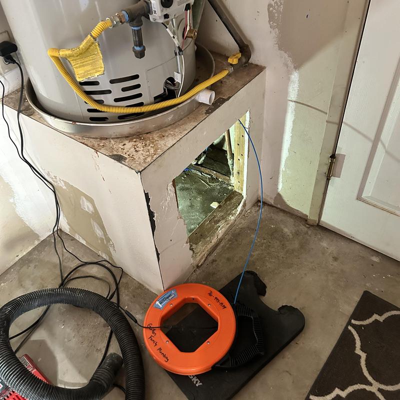 Water heater plumbing with leak detection equipment in basement