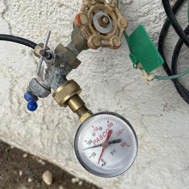 Water pressure gauge attached to outdoor valve