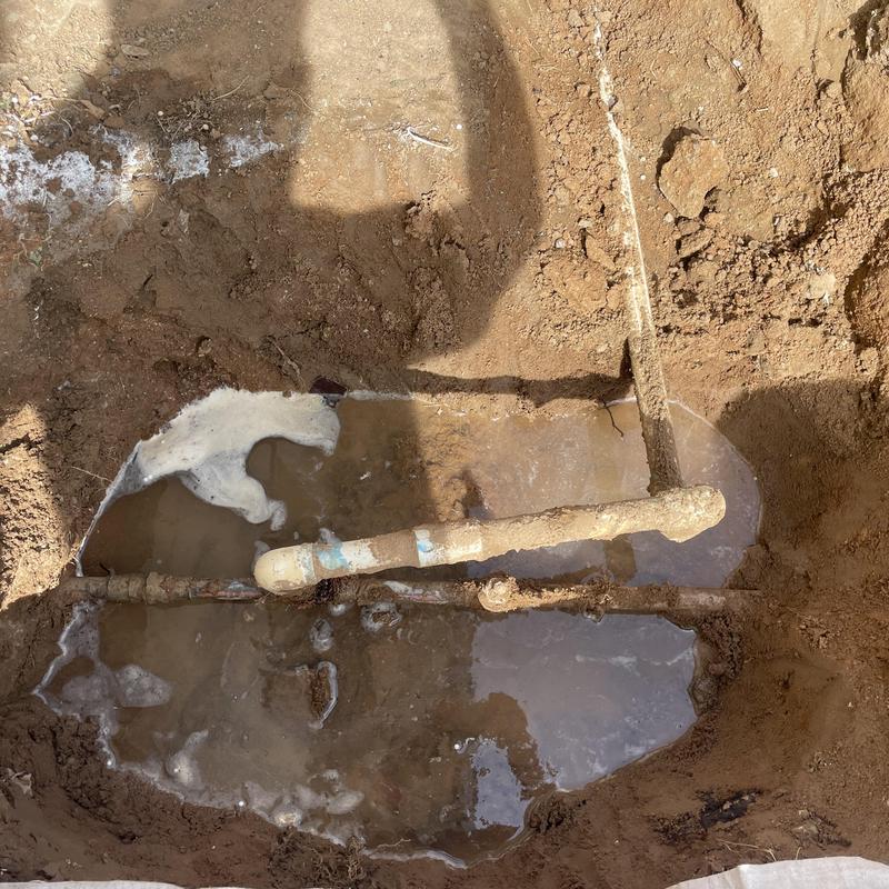 Galvanized and PVC water line leak in excavated yard