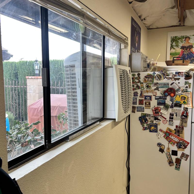 Swamp cooler installed in kitchen window with magnets