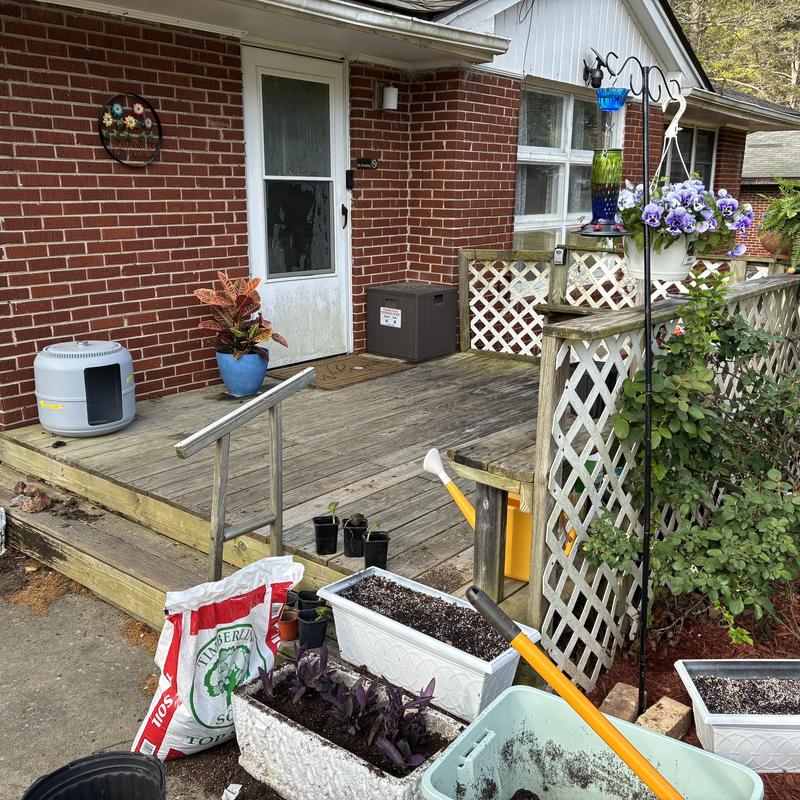 Wooden front porch with railing and lattice panels