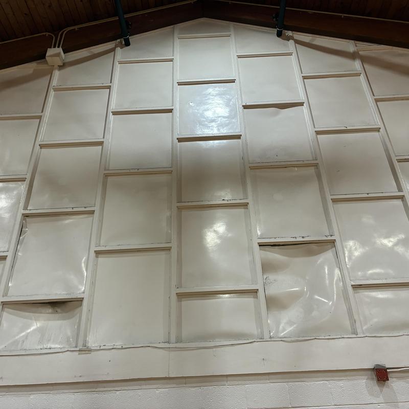 Interior wall panels with dents and warping visible